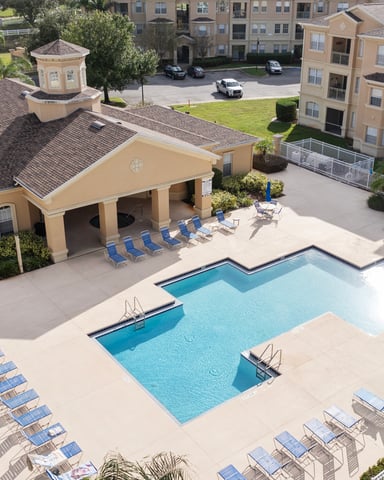 Community pool with pergola and outdoor lounge area